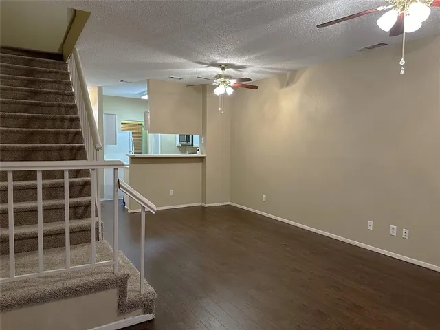 a view of a livingroom with a ceiling fan and window