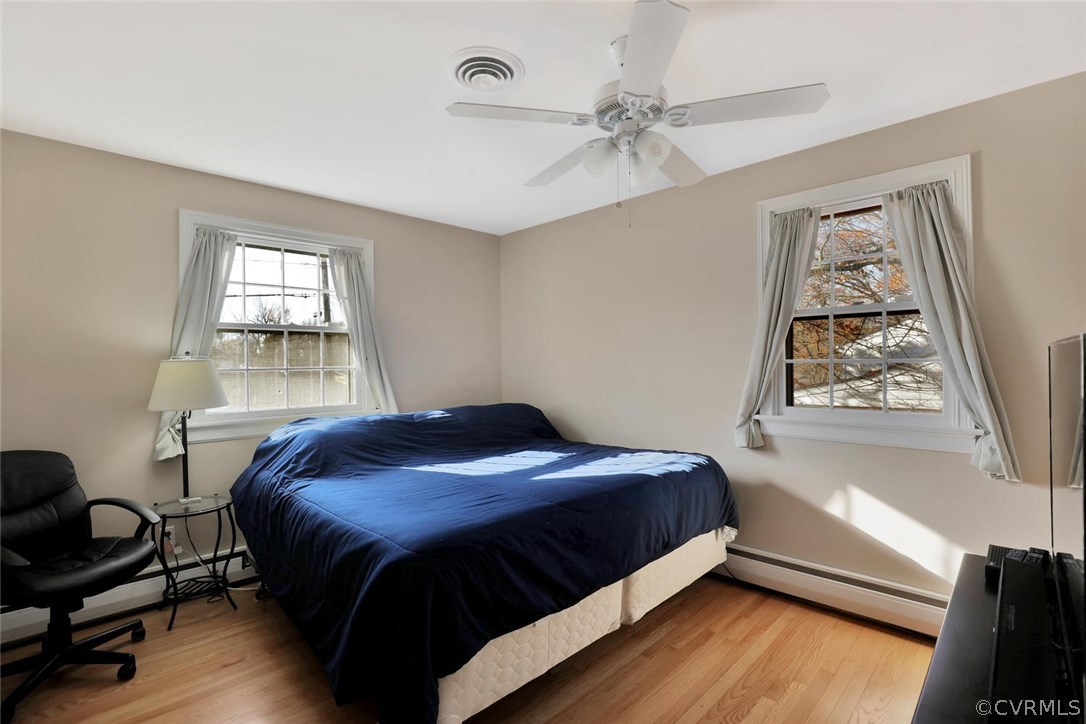 9320 Three Chopt Road Henrico, VA 23229 - Photo 21 of 32 a bedroom with a bed and wooden floor
