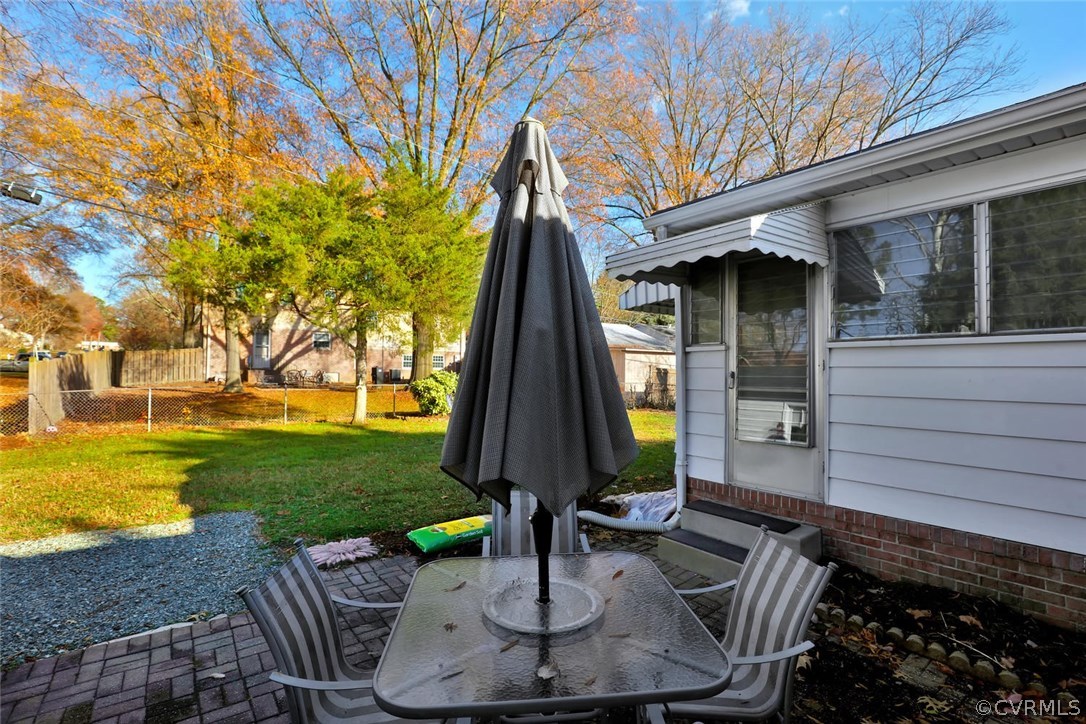 9320 Three Chopt Road Henrico, VA 23229 - Photo 27 of 32 a view of a patio with a table chairs potted plants and a large tree