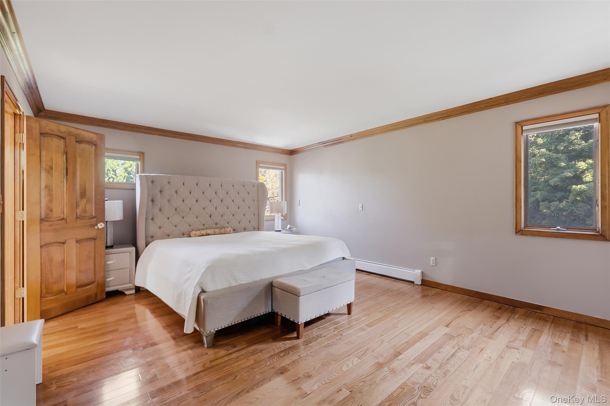 985 Craigville Road Chester, NY 10918 - Photo 19 of 36 Spacious room featuring wood-finish flooring, natural wood door, wood-framed windows, and wood trim accents