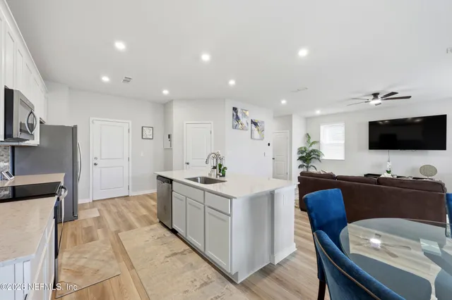 a kitchen with stainless steel appliances kitchen island granite countertop a sink and a stove