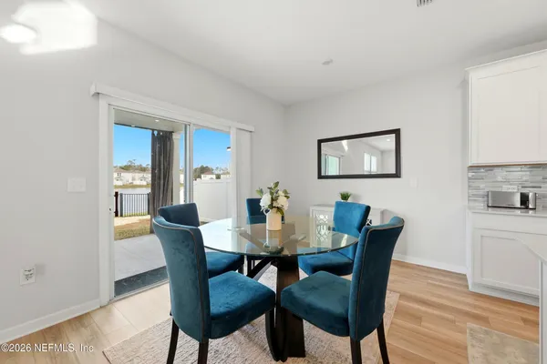 a view of a dining room with furniture and wooden floor