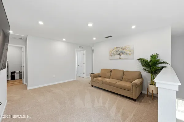 a living room with furniture and a potted plant