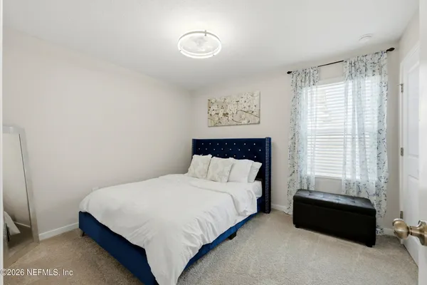 a bedroom with a bed and a window