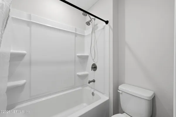 a bathroom with a bathtub and a toilet