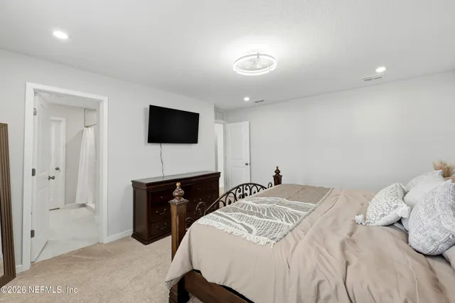 a bed room with a bed and a television