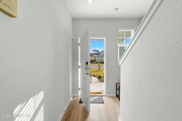 a view of a bedroom with wooden floor and windows