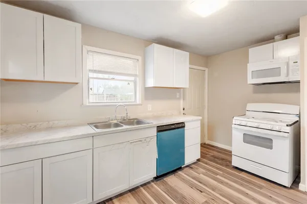 a kitchen with a sink stove and cabinets