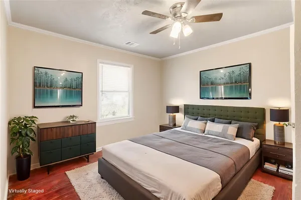 a bedroom with a large bed and a chandelier