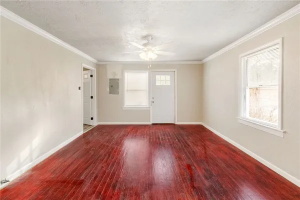 wooden floor in an empty room with a window