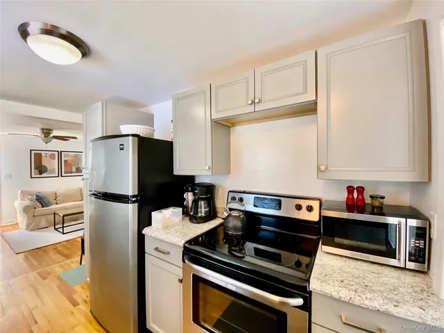 a kitchen with a refrigerator and a stove top oven