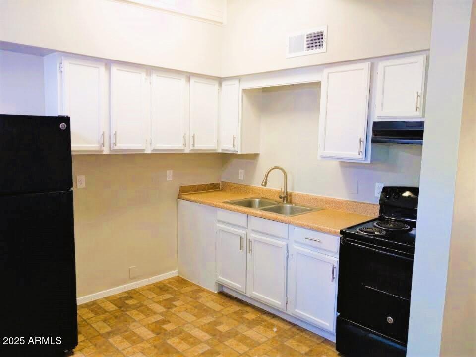 50 North Casa Grande Avenue, Unit 6 Casa Grande, AZ 85122 - Photo 4 of 9 a kitchen with granite countertop a sink a stove and refrigerator