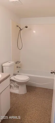 a bathroom with a toilet a sink and bathtub