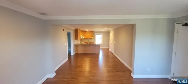 a view of wooden floor and windows in an empty room