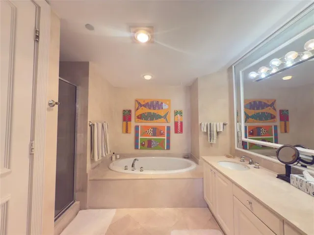 a bathroom with a tub sink and mirror