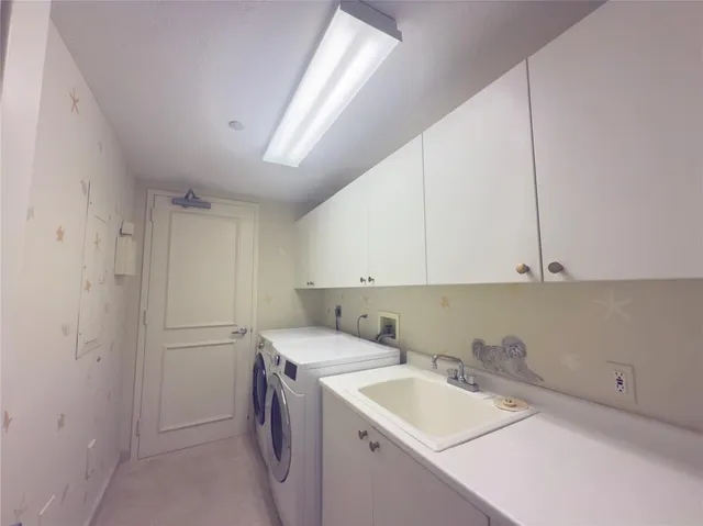 a view of a storage and utility room with a sink