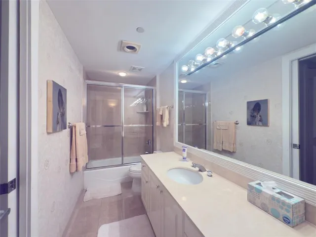 a bathroom with a double vanity sink mirror and shower