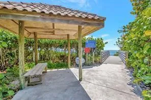 a view of a patio with table and chairs under an umbrella