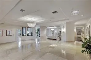 a view of a hallway with livingroom and furniture