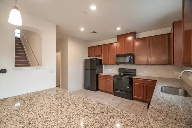 a bathroom with a sink a vanity and a large mirror