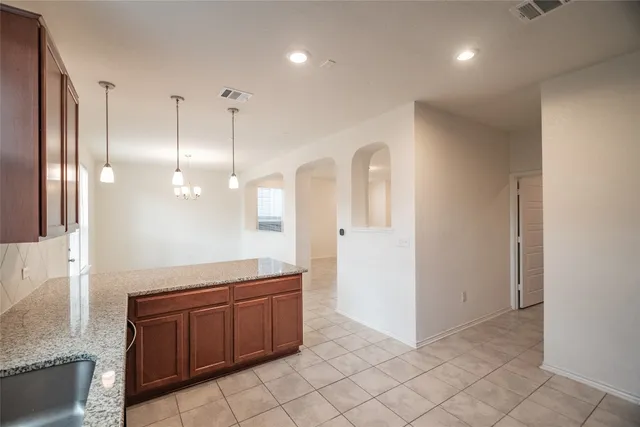 a bathroom with a granite countertop sink a toilet and a mirror