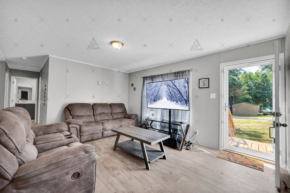 107 Clearwater Shores Road Fair Play, SC 29643 - Photo 21 of 23 Smooth wood-style flooring and natural light streaming through a glass door define this inviting space.