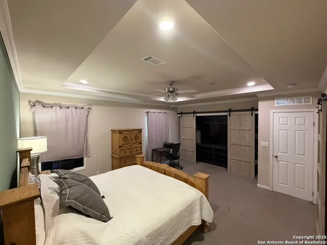 a bedroom with a large bed and a bathroom