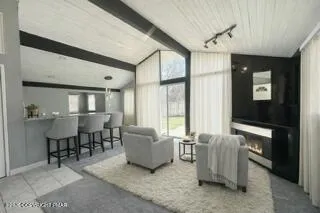a kitchen with stainless steel appliances kitchen island granite countertop a refrigerator and a sink