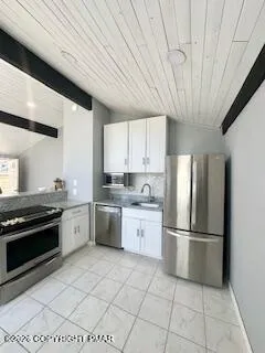 a spacious bathroom with a double vanity sink a mirror and a shower