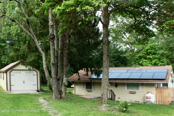 a front view of house with yard and green space