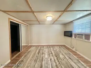 an empty room with a window and a fan