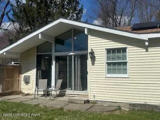 a view of a house with backyard and sitting area