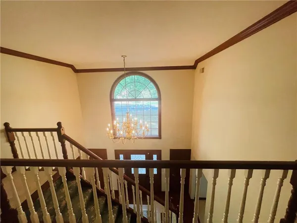 an empty room with a ceiling fan and window