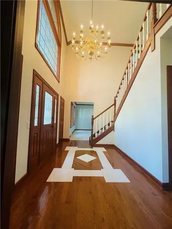 a view of entryway and hall with wooden floor