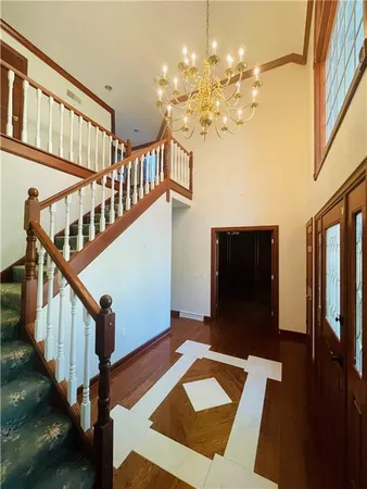 a view of a hallway with front door and wooden floor