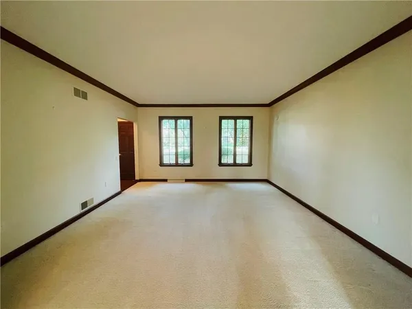 a view of an empty room with windows