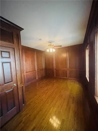 a view of empty room with wooden floor