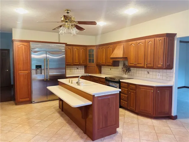 a kitchen with a stove a refrigerator and wooden cabinets