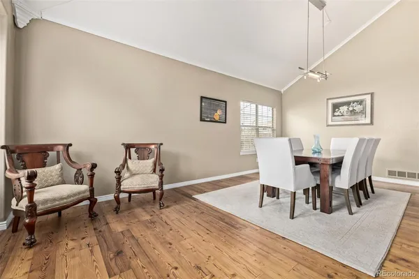 a view of a dining room with furniture and wooden floor