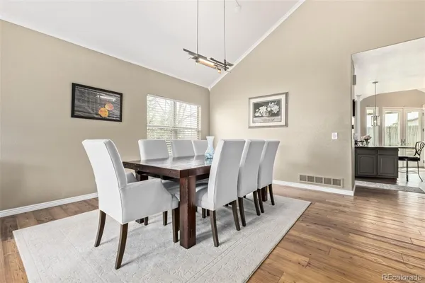 a view of a dining room with furniture and wooden floor