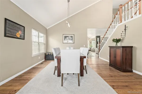 a view of a dining room with furniture and wooden floor