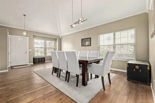 a view of a dining room with furniture and wooden floor