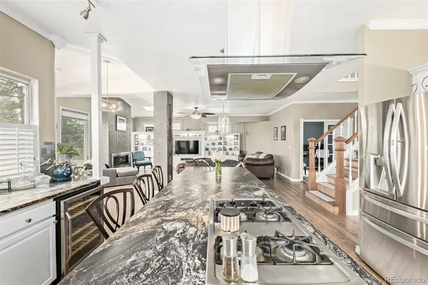 a very nice looking living room with a large window and stainless steel appliances