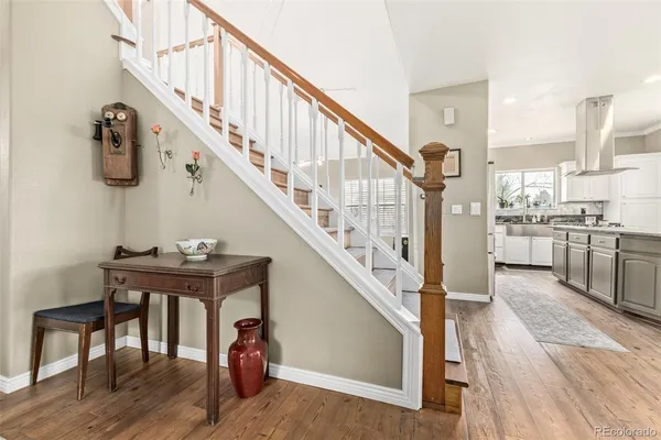 a view of entryway and hall with wooden floor