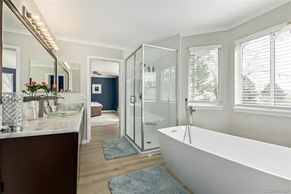 a spacious bathroom with sink shower and bathtub