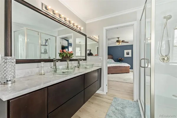 a en suite bathroom with a double vanity sink and a mirror
