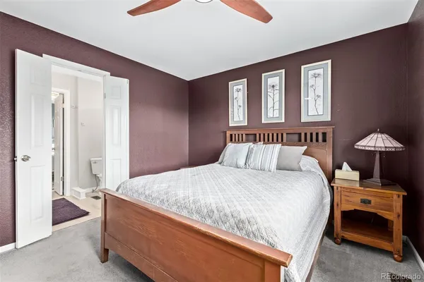 a bedroom with a bed and a lamp