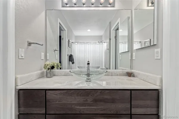 a view of bathroom with sink and mirror