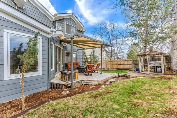a view of a house with backyard porch and sitting area