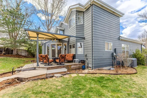 a view of a house with backyard and sitting area